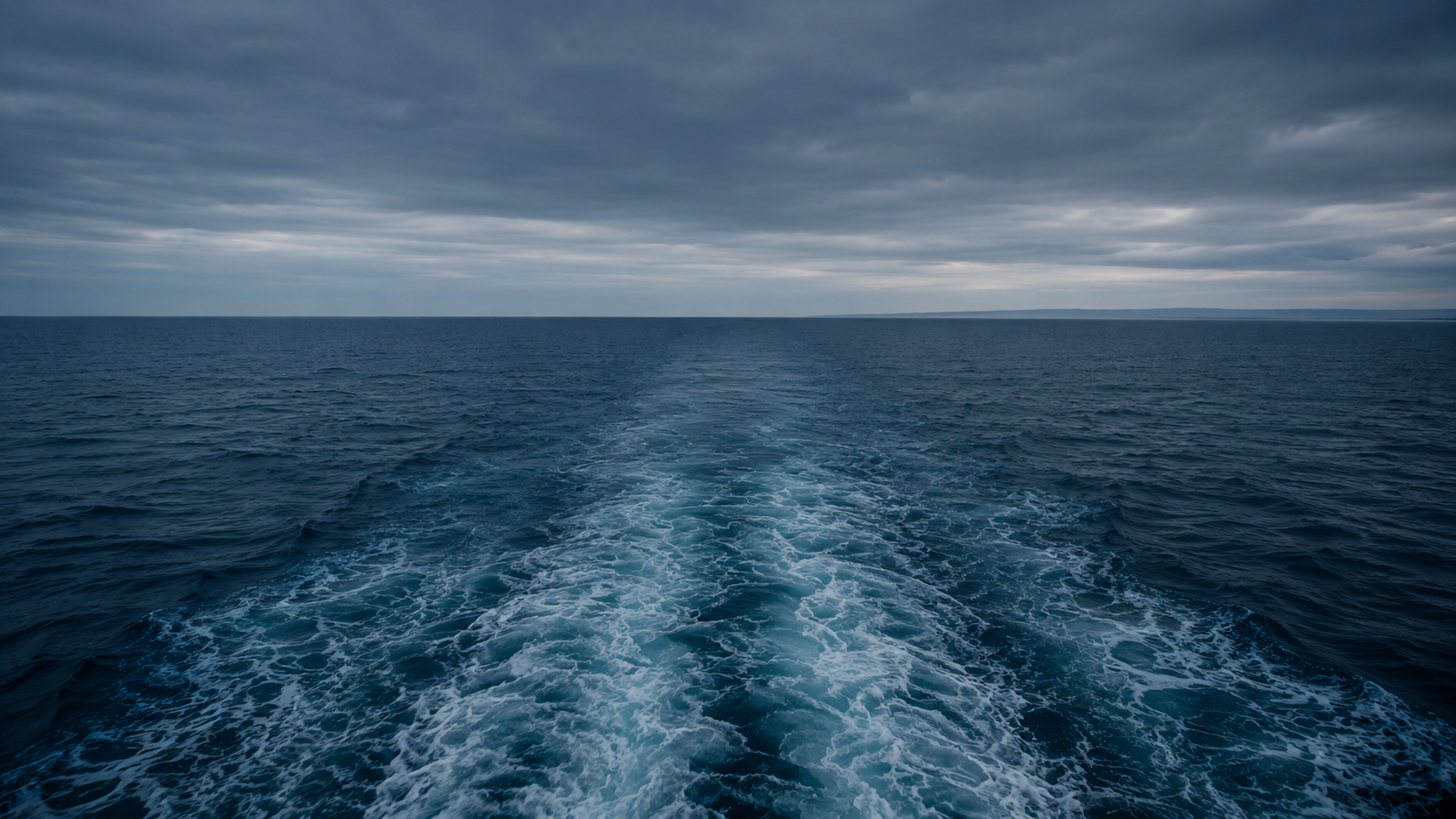 DOHSA vs. the Jones Act wrongful death beyond 3 nautical miles, open sea with a distant shoreline on the horizon seen from a vessel far from land.